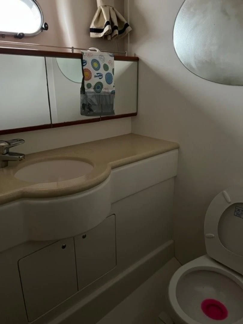 a bathroom with a toilet and sink aboard JOIE DU ROI Yacht for Sale