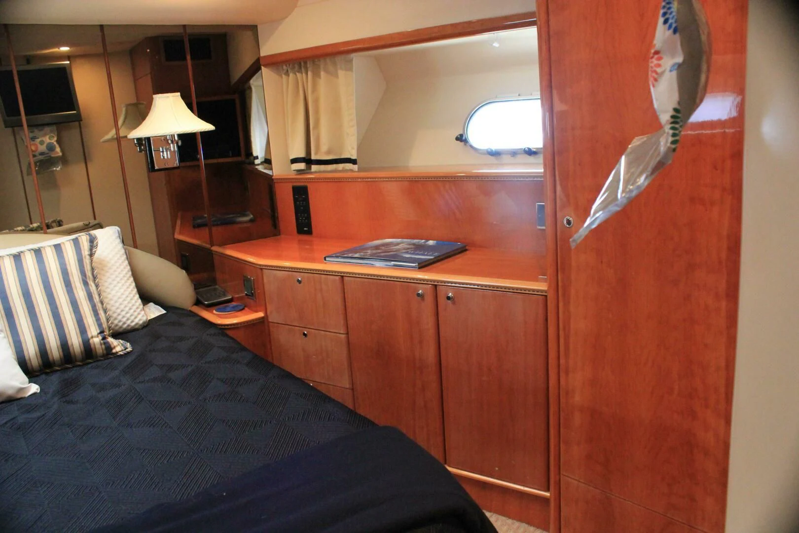 a bedroom with a desk and a bed aboard JOIE DU ROI Yacht for Sale