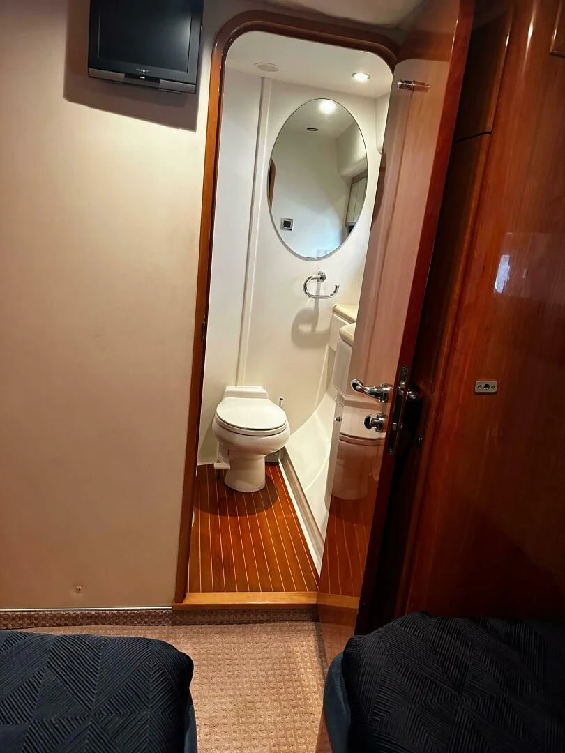 a bathroom with a mirror and a toilet aboard JOIE DU ROI Yacht for Sale