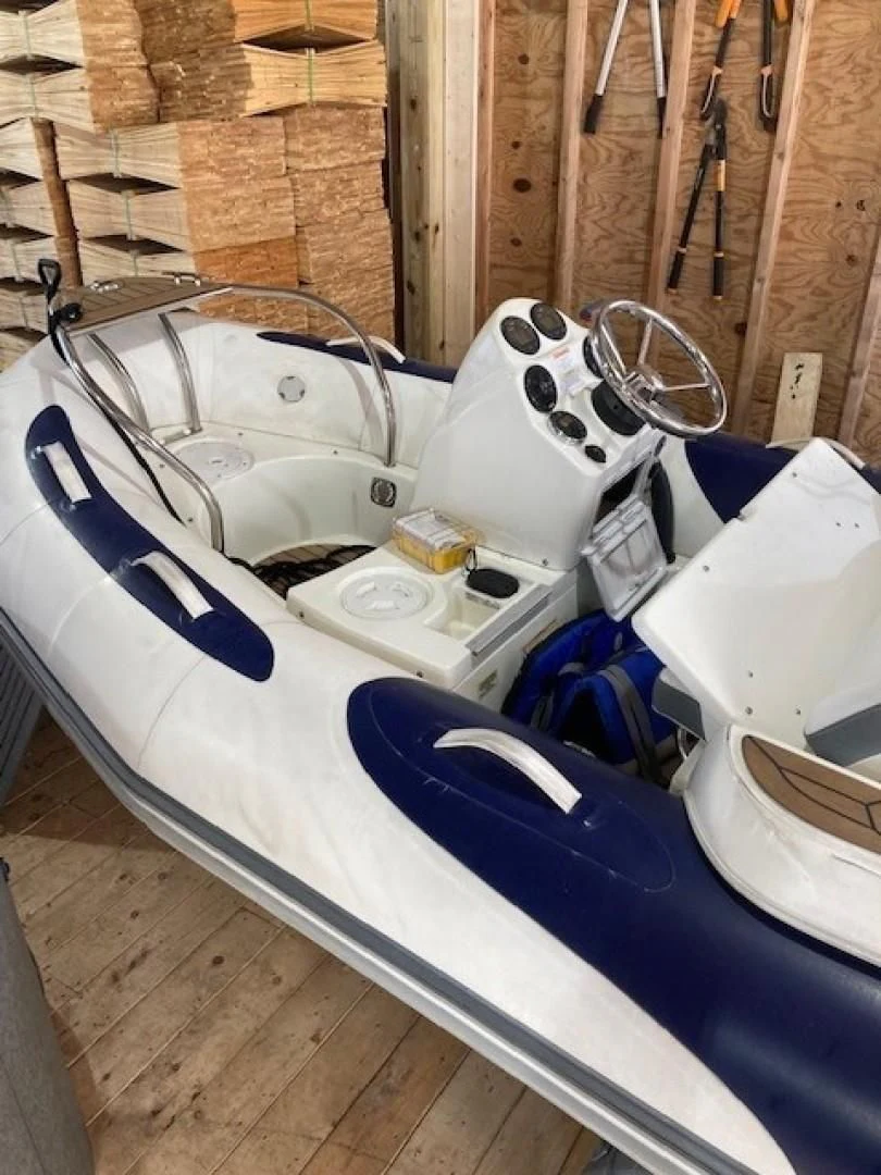 a group of white and blue and silver boats on a wooden deck aboard JOIE DU ROI Yacht for Sale