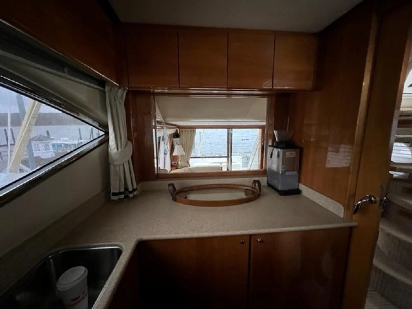a kitchen with a sink and a window aboard JOIE DU ROI Yacht for Sale