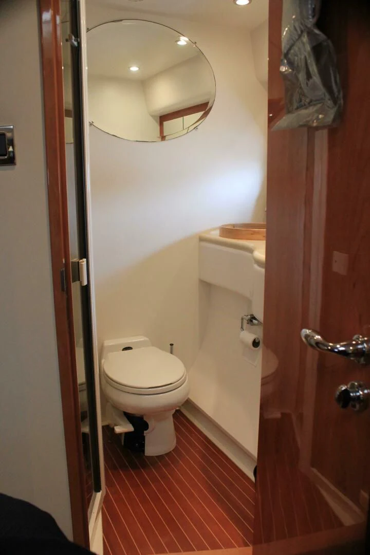 a bathroom with a toilet and a mirror aboard JOIE DU ROI Yacht for Sale