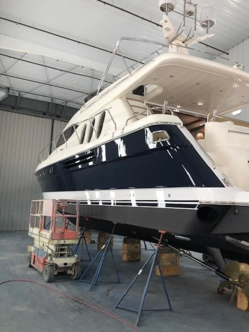 a large white boat in a large garage aboard JOIE DU ROI Yacht for Sale