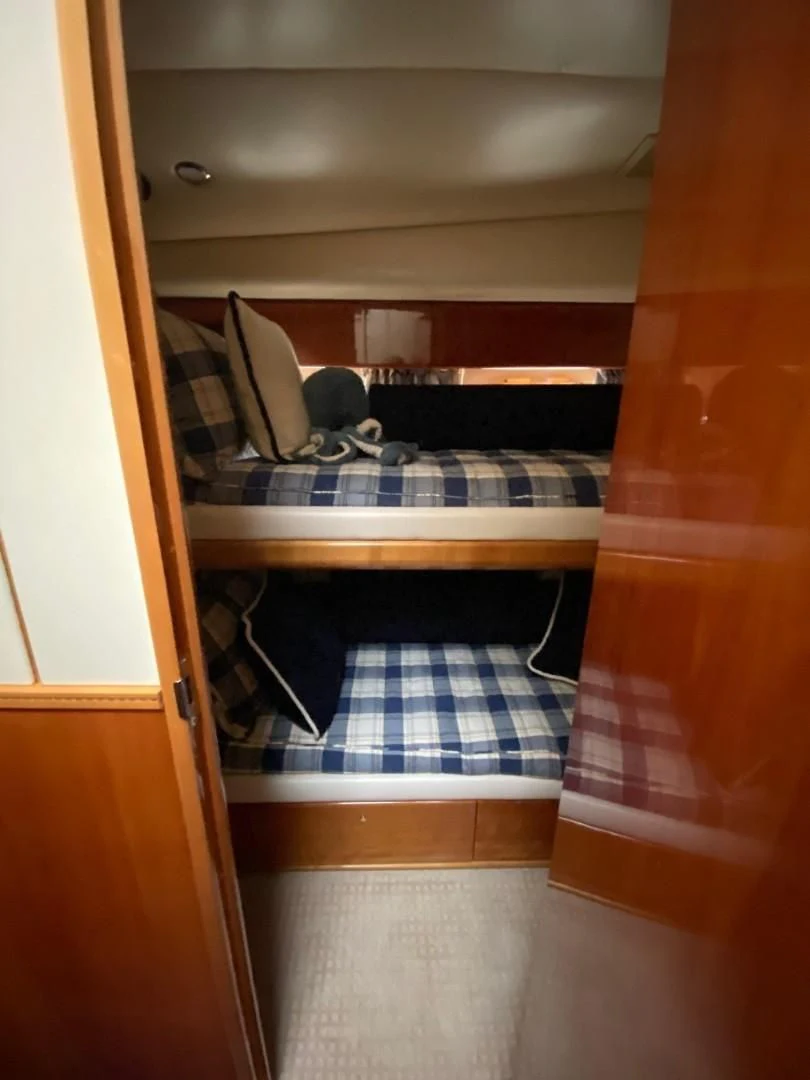 a room with a bed and a table aboard JOIE DU ROI Yacht for Sale