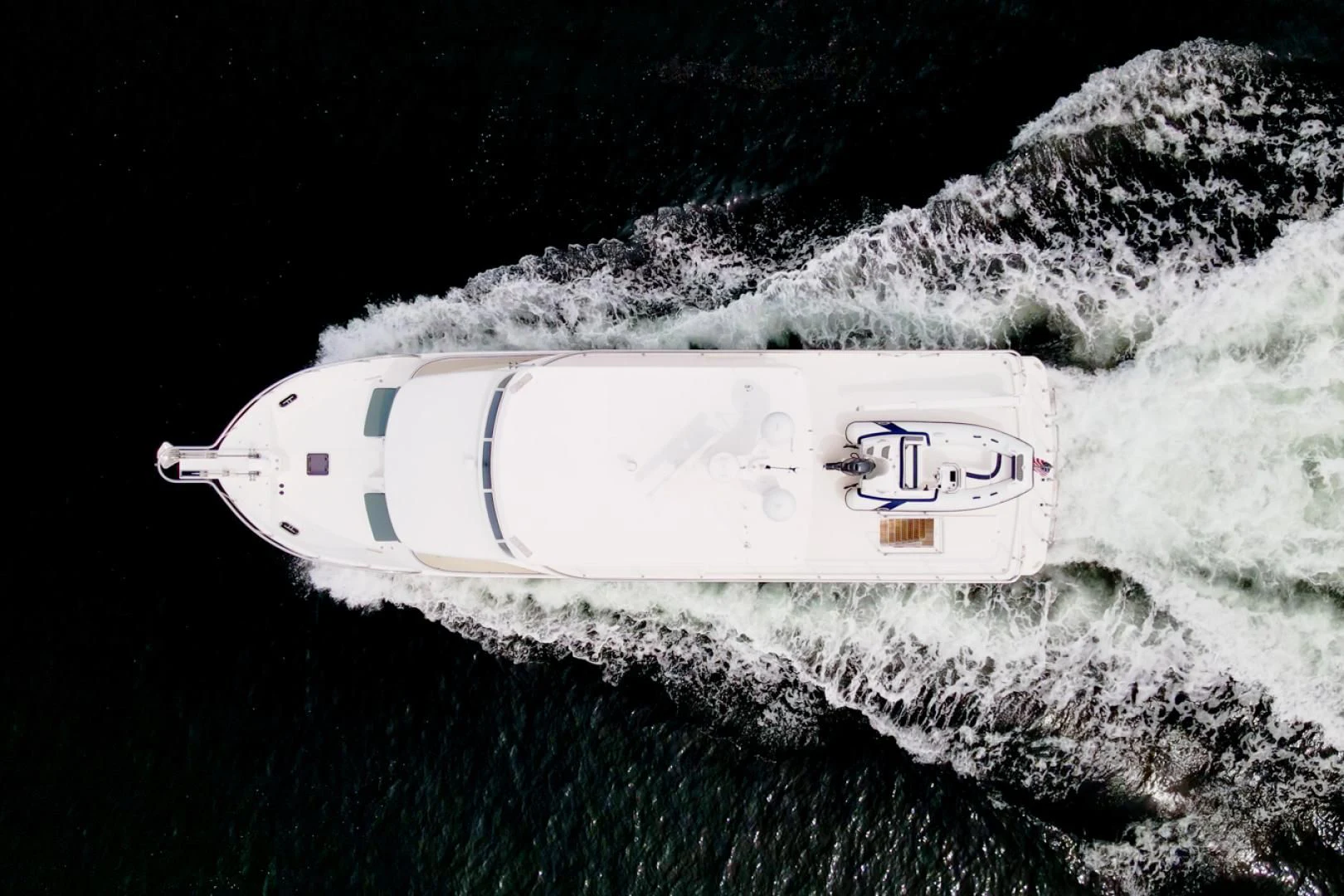 a bottle of champagne on a snowy mountain aboard MAHALO Yacht for Sale