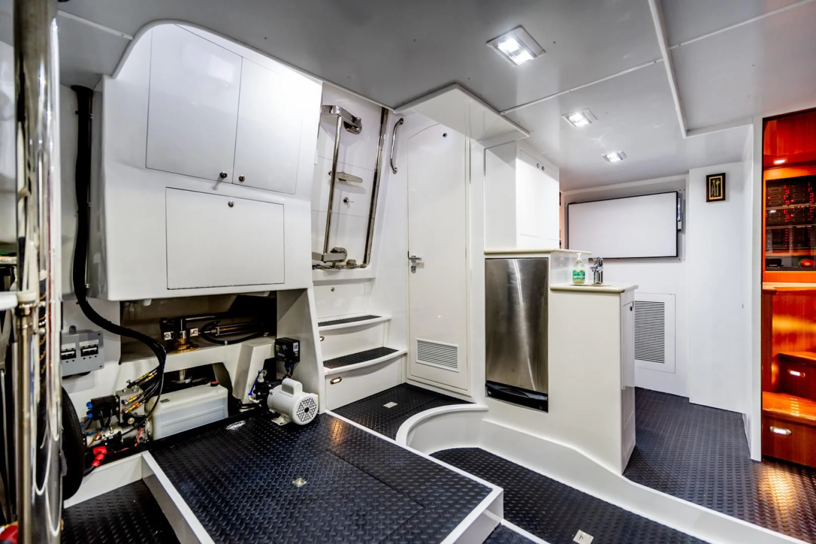a room with a large black and white machine and a black floor aboard MAHALO Yacht for Sale