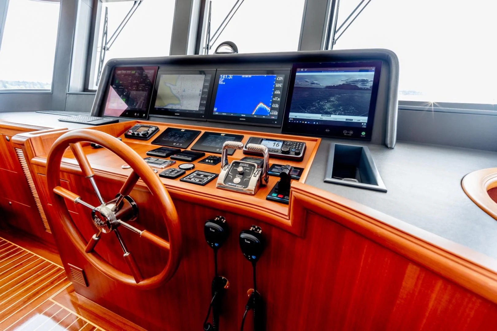 a wooden desk with computers and electronics aboard MAHALO Yacht for Sale