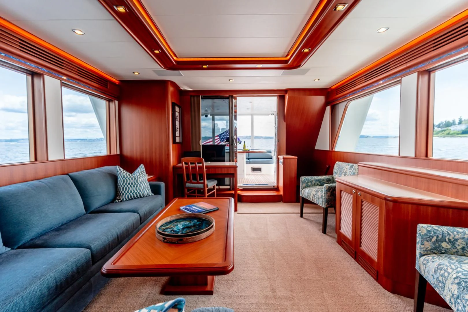 a living room with a couch and a coffee table aboard MAHALO Yacht for Sale