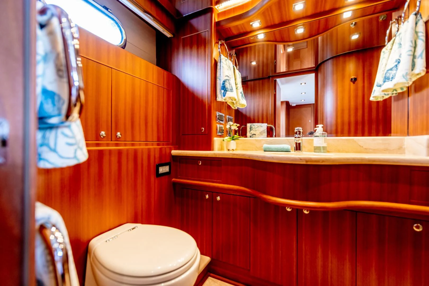 a bathroom with a mirror and a toilet aboard MAHALO Yacht for Sale