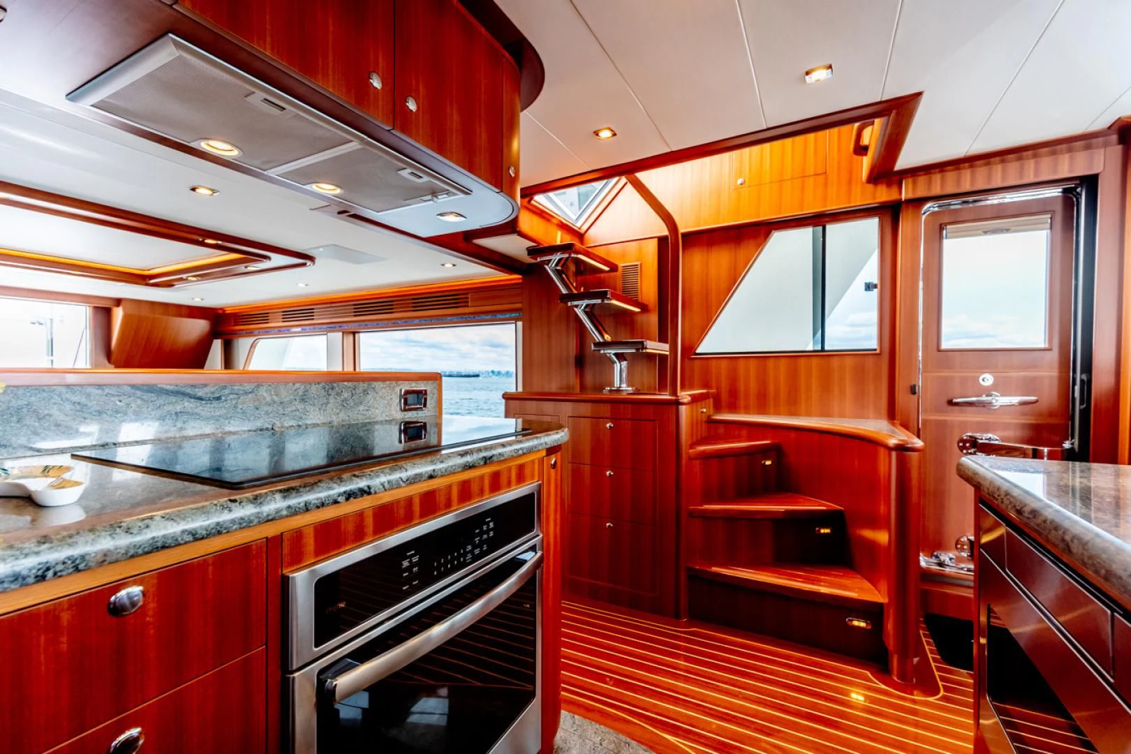 a kitchen with wooden cabinets aboard MAHALO Yacht for Sale