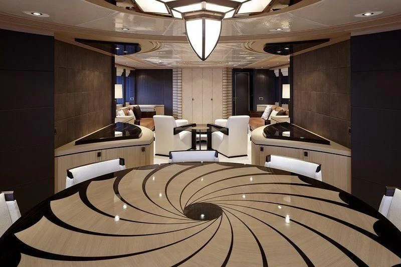 a room with a large table and chairs aboard TAURICA Yacht for Sale