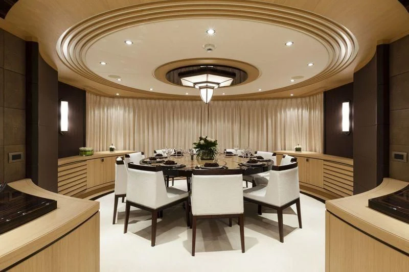 a large kitchen with a table and chairs aboard TAURICA Yacht for Sale
