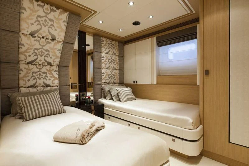 a room with a bed and a large mirror aboard TAURICA Yacht for Sale