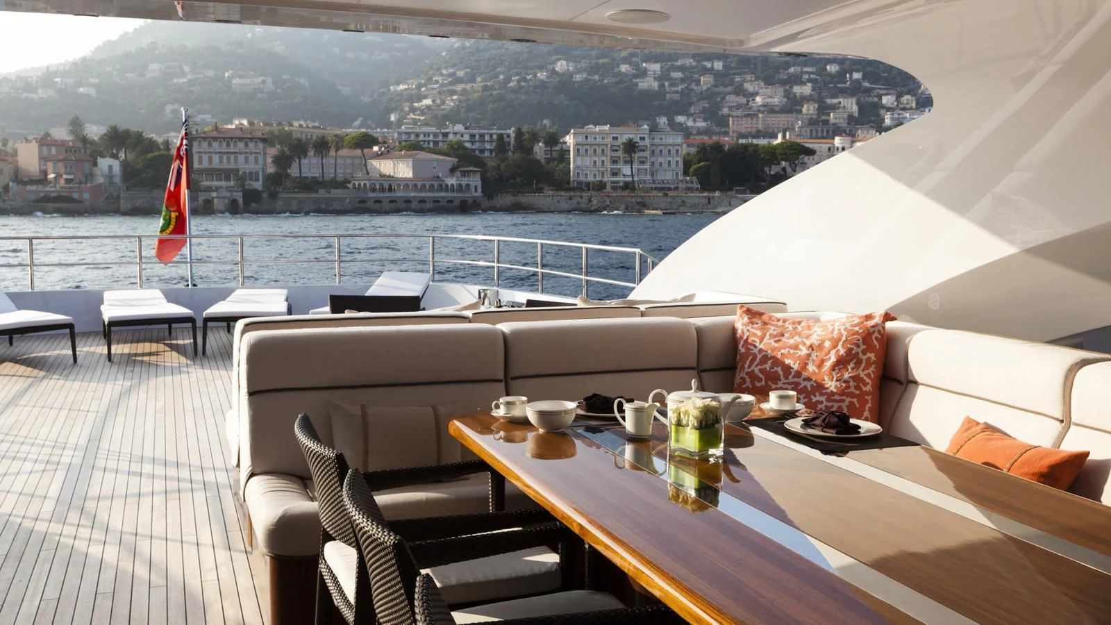 a table with chairs and a flag on it aboard TAURICA Yacht for Sale