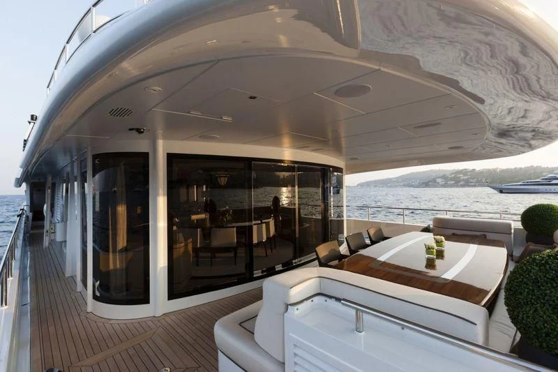 a room with a bed and a table and chairs aboard TAURICA Yacht for Sale