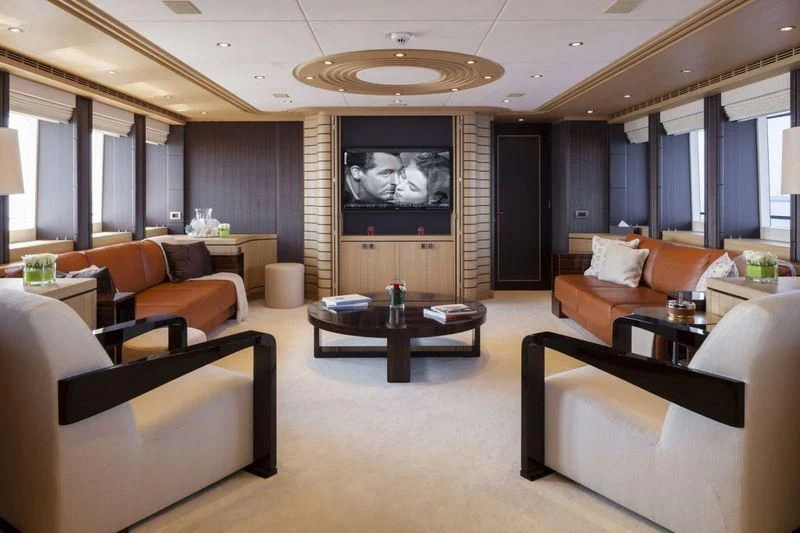 a living room with a large screen aboard TAURICA Yacht for Sale