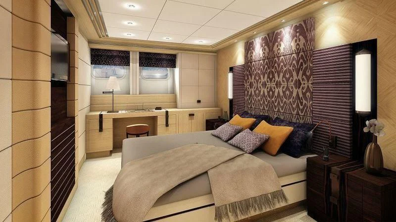 a bedroom with a bed and desk aboard TAURICA Yacht for Sale