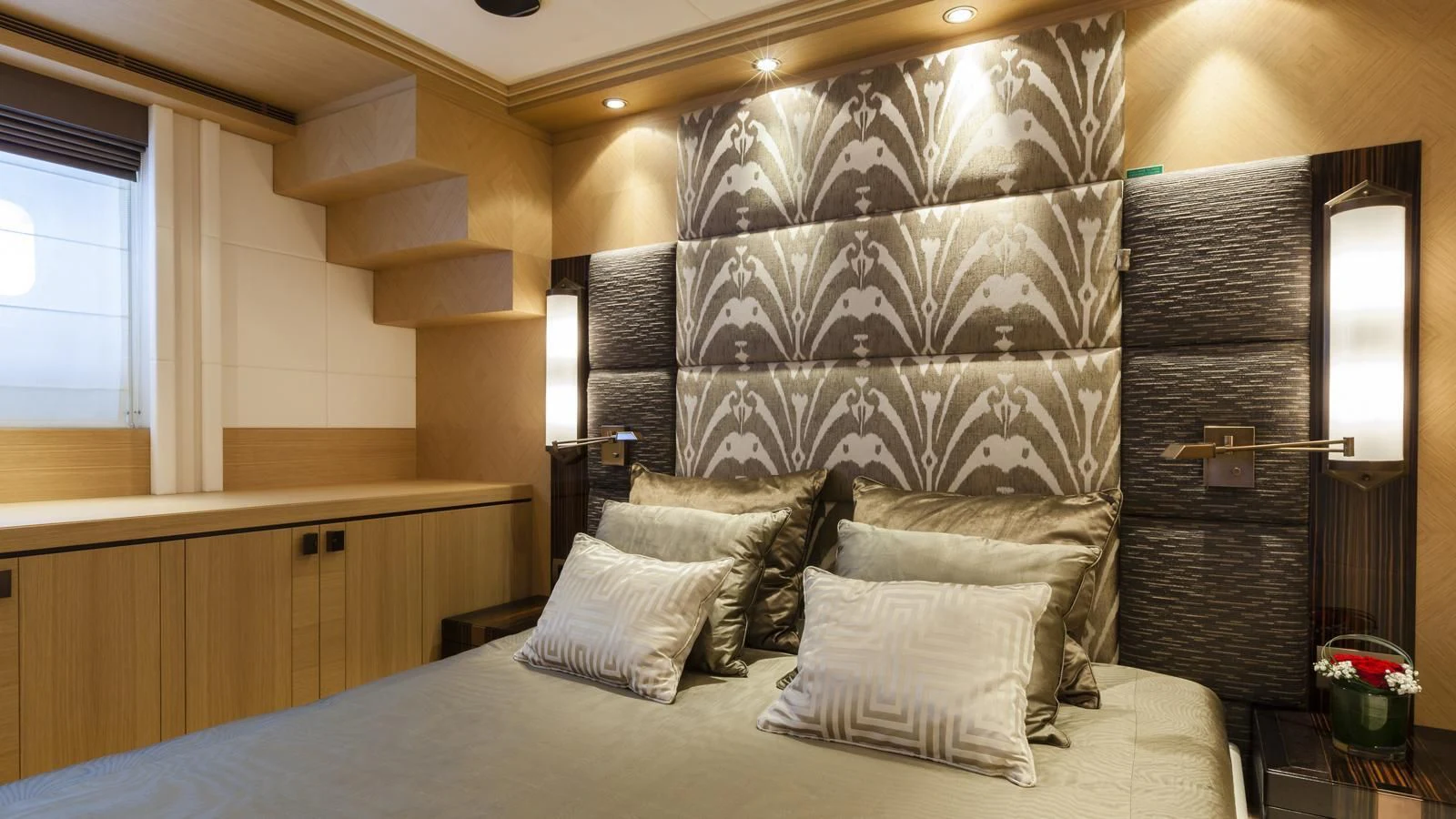 a bed with a large headboard aboard TAURICA Yacht for Sale