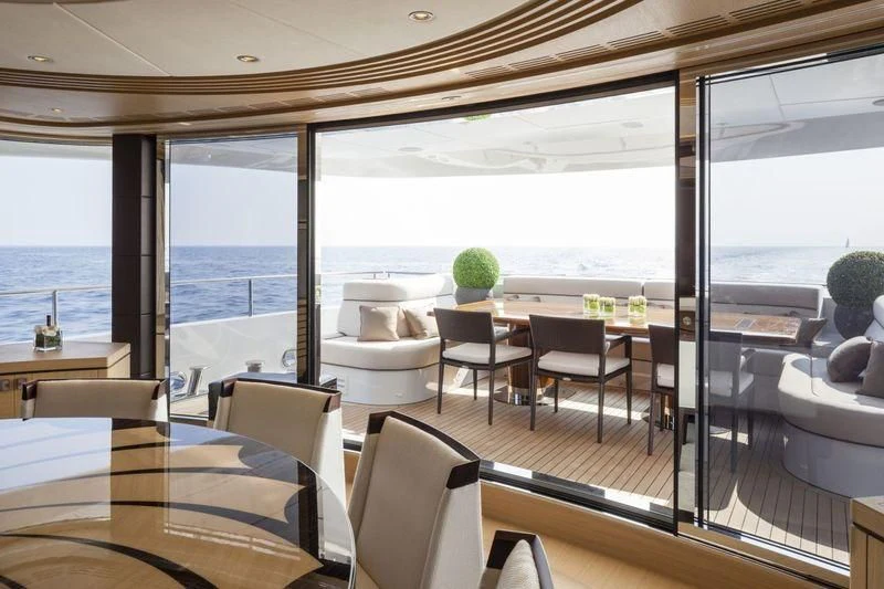 a room with a table and chairs aboard TAURICA Yacht for Sale