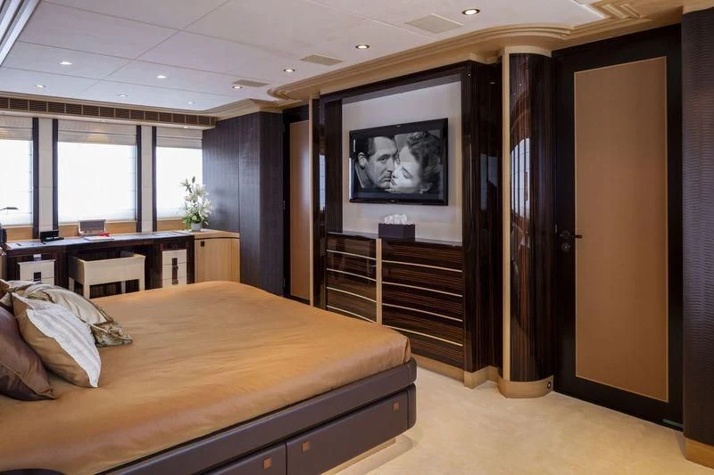 a bedroom with a large tv aboard TAURICA Yacht for Sale