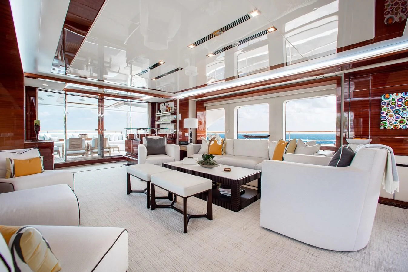 a room with white couches and a table aboard ALLORA Yacht for Sale