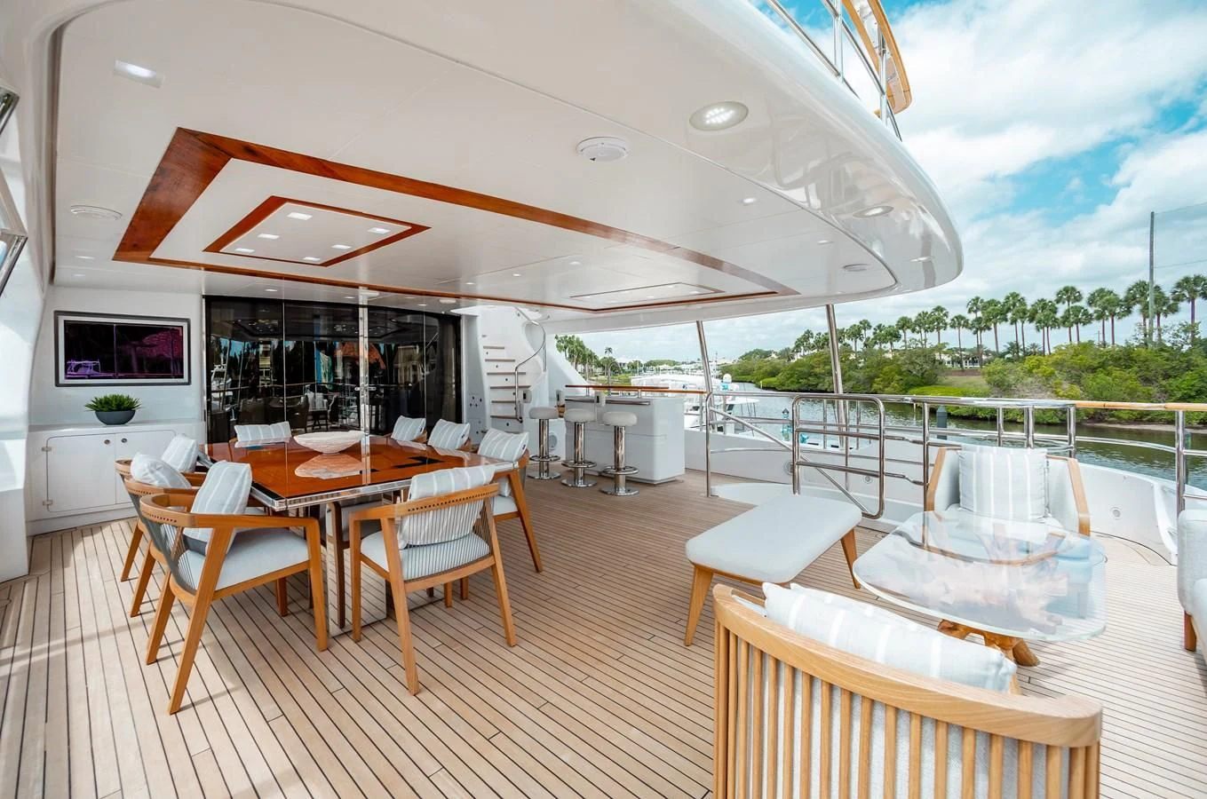 a deck with a table and chairs aboard ALLORA Yacht for Sale