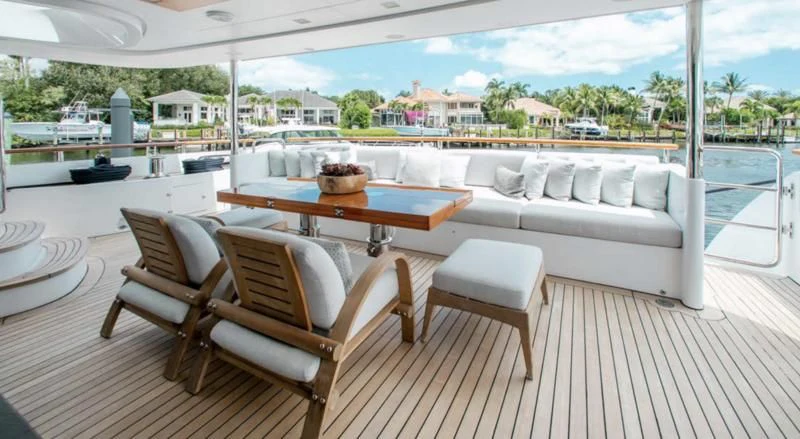 a table and chairs on a deck aboard ALLORA Yacht for Sale
