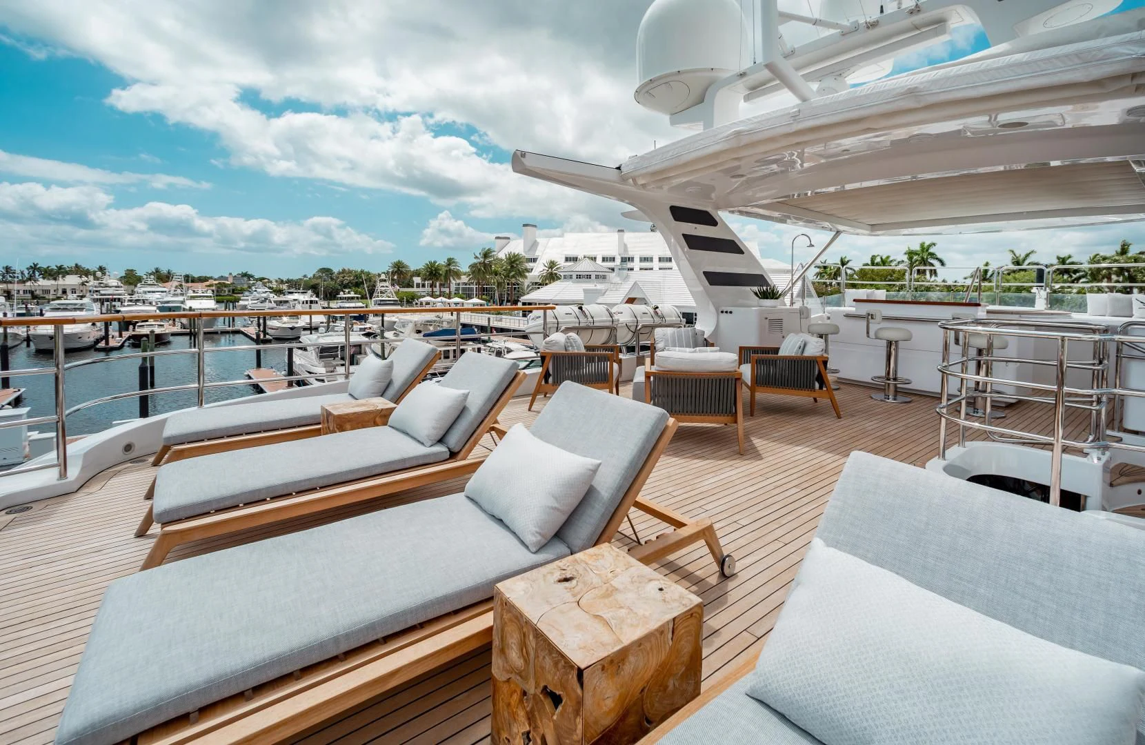 a room with a large deck and a view of the water aboard ALLORA Yacht for Sale
