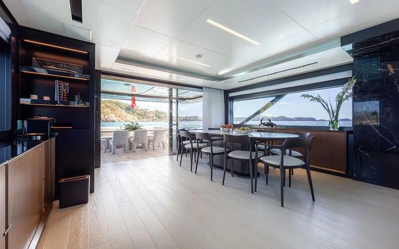 a room with a table and chairs aboard LEMON NOT LIME Yacht for Sale
