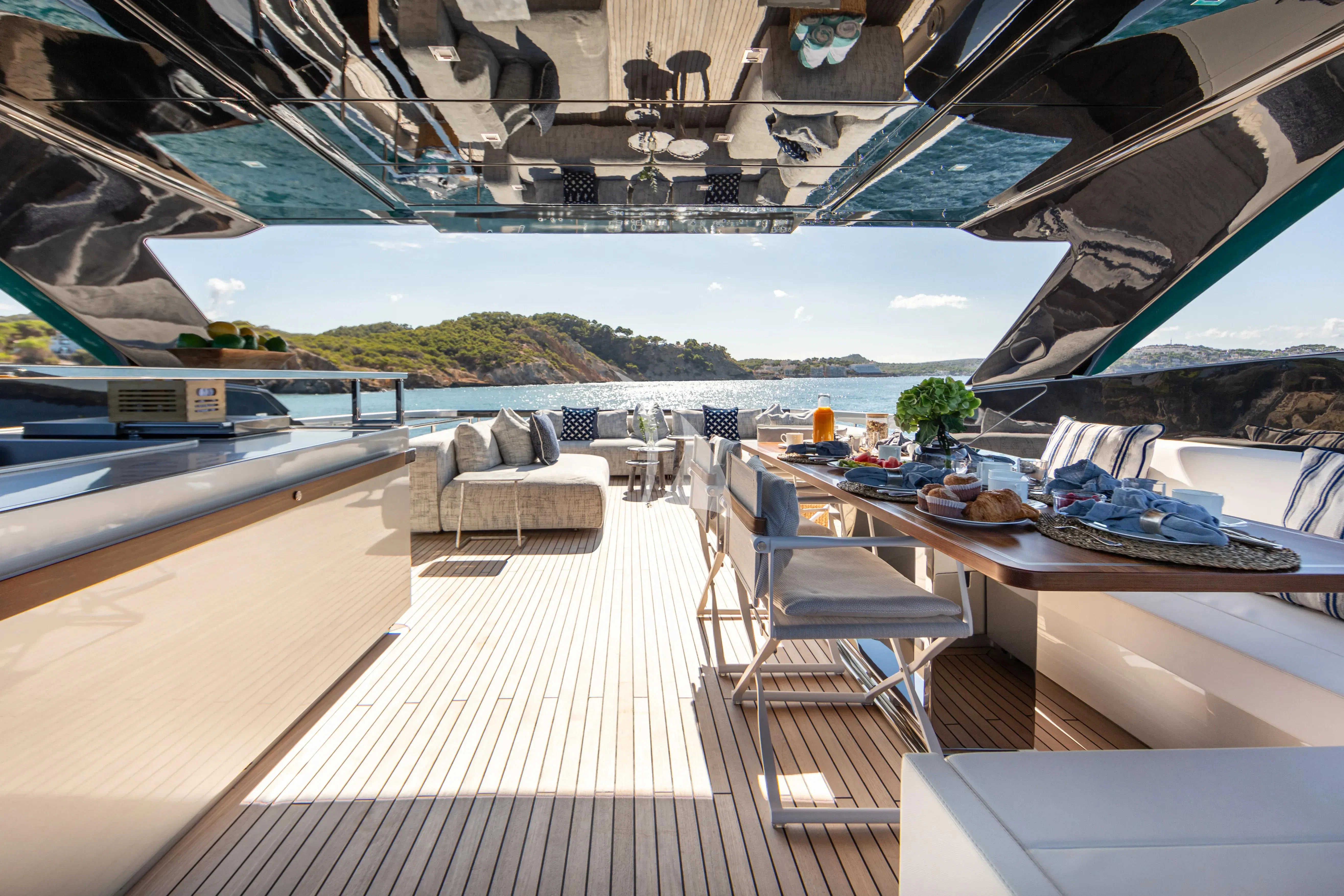 a room with a pool and a deck with chairs and tables aboard LEMON NOT LIME Yacht for Sale