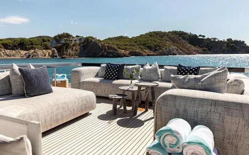 a patio with couches and tables aboard LEMON NOT LIME Yacht for Sale