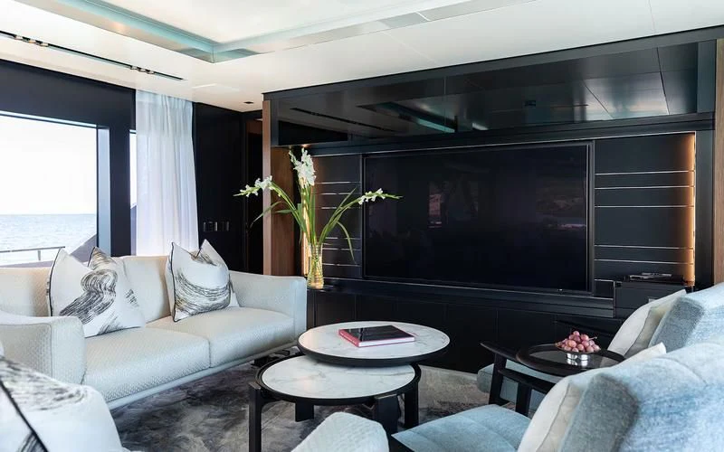 a living room with a large screen aboard LEMON NOT LIME Yacht for Sale