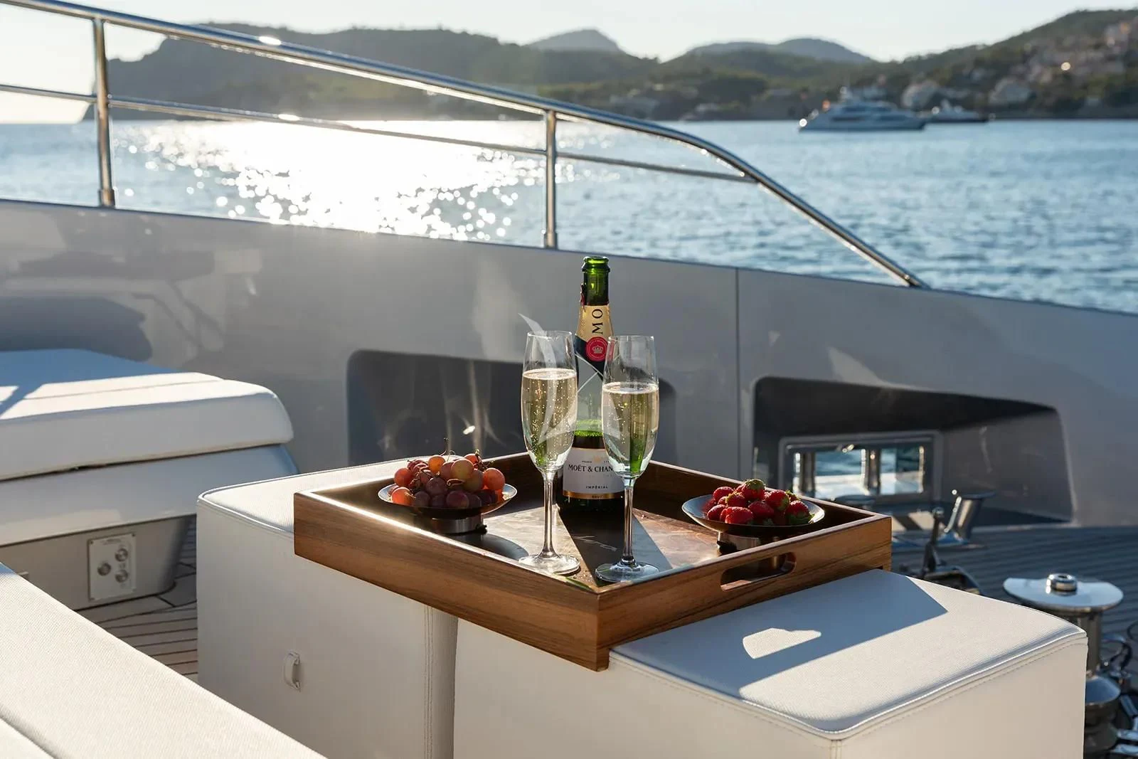 a glass of champagne on a table with a view of a city aboard LEMON NOT LIME Yacht for Sale