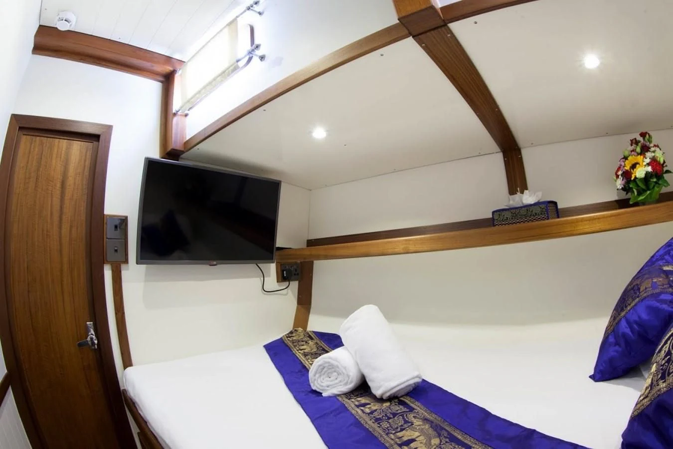 a room with a bed and a television aboard DALLINGHOO Yacht for Sale