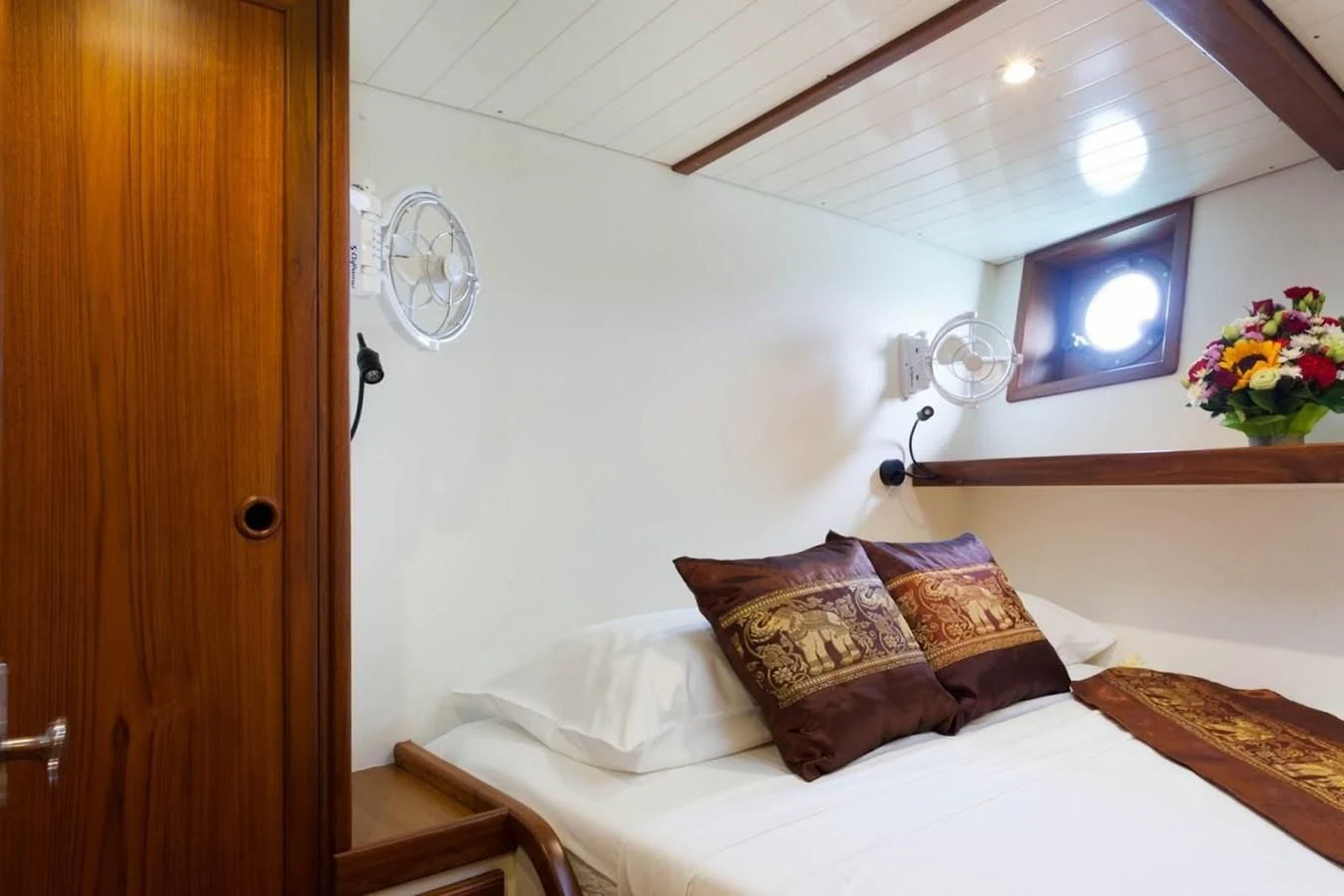 a bed with a television on the wall aboard DALLINGHOO Yacht for Sale