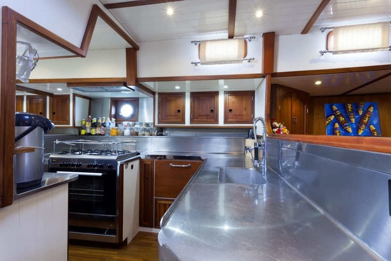 a kitchen with wooden cabinets aboard DALLINGHOO Yacht for Sale