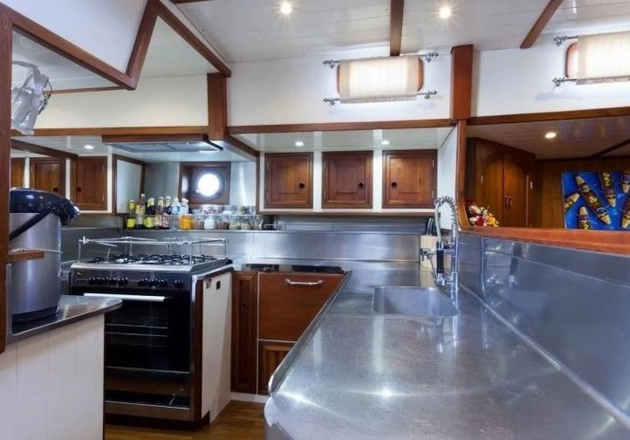 a kitchen with wooden cabinets aboard DALLINGHOO Yacht for Sale