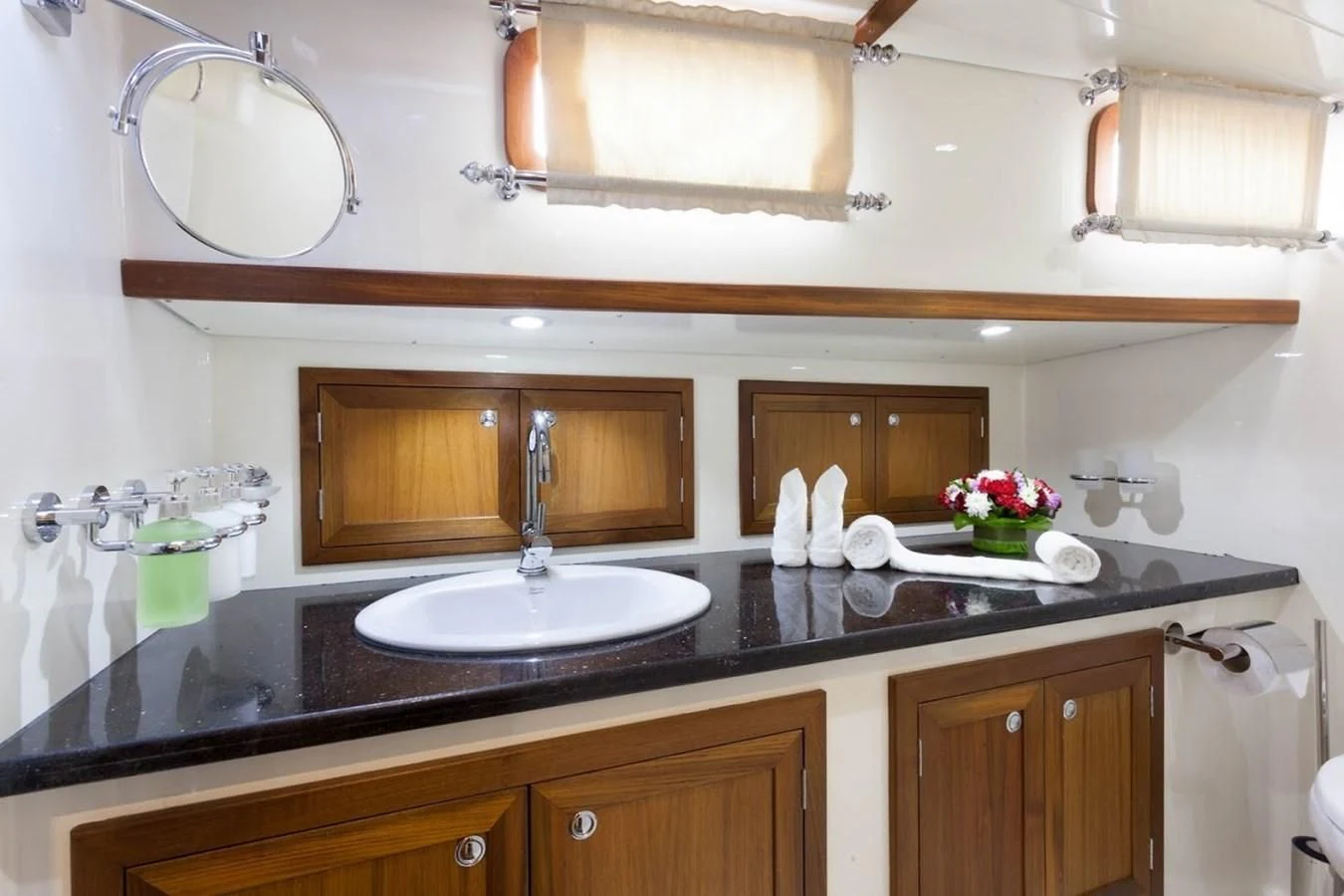 a bathroom with a sink and a mirror aboard DALLINGHOO Yacht for Sale