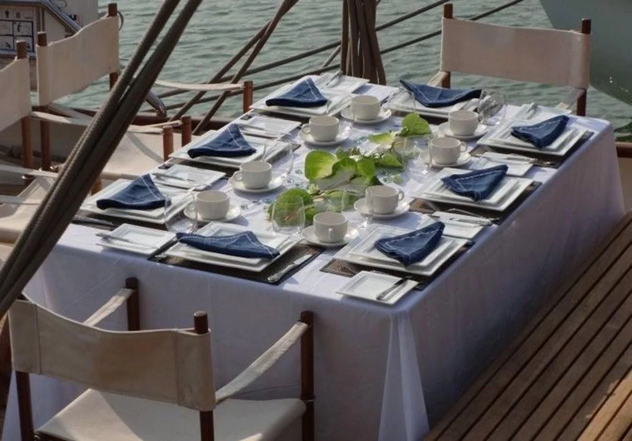 a table with a cloth and cups on it aboard DALLINGHOO Yacht for Sale