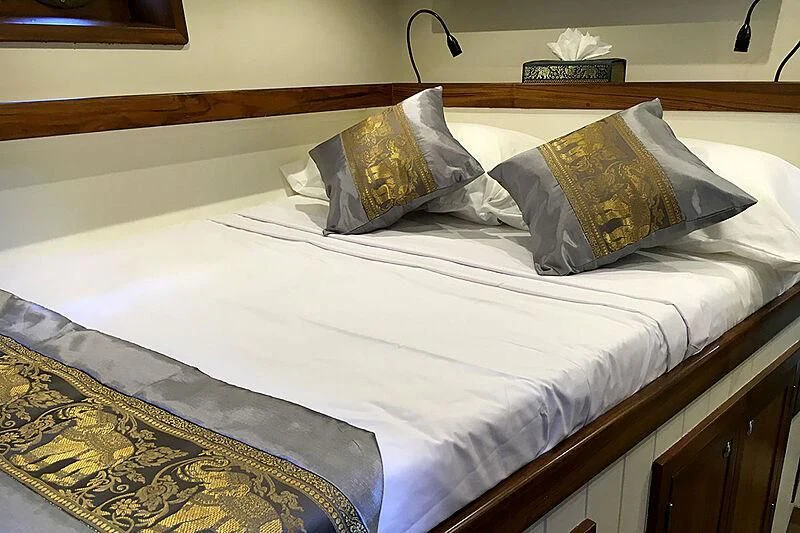 a bed with white sheets aboard DALLINGHOO Yacht for Sale