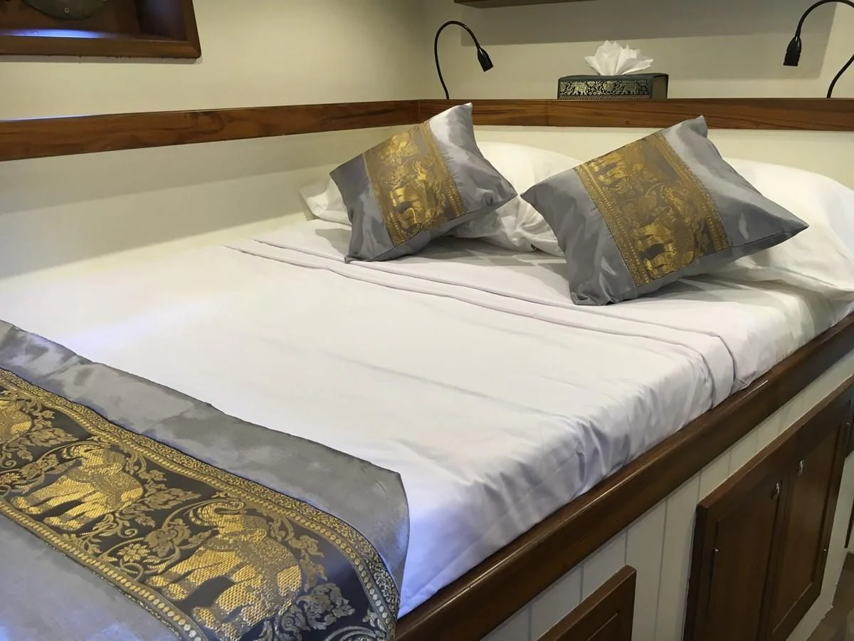 a bed with white sheets aboard DALLINGHOO Yacht for Sale