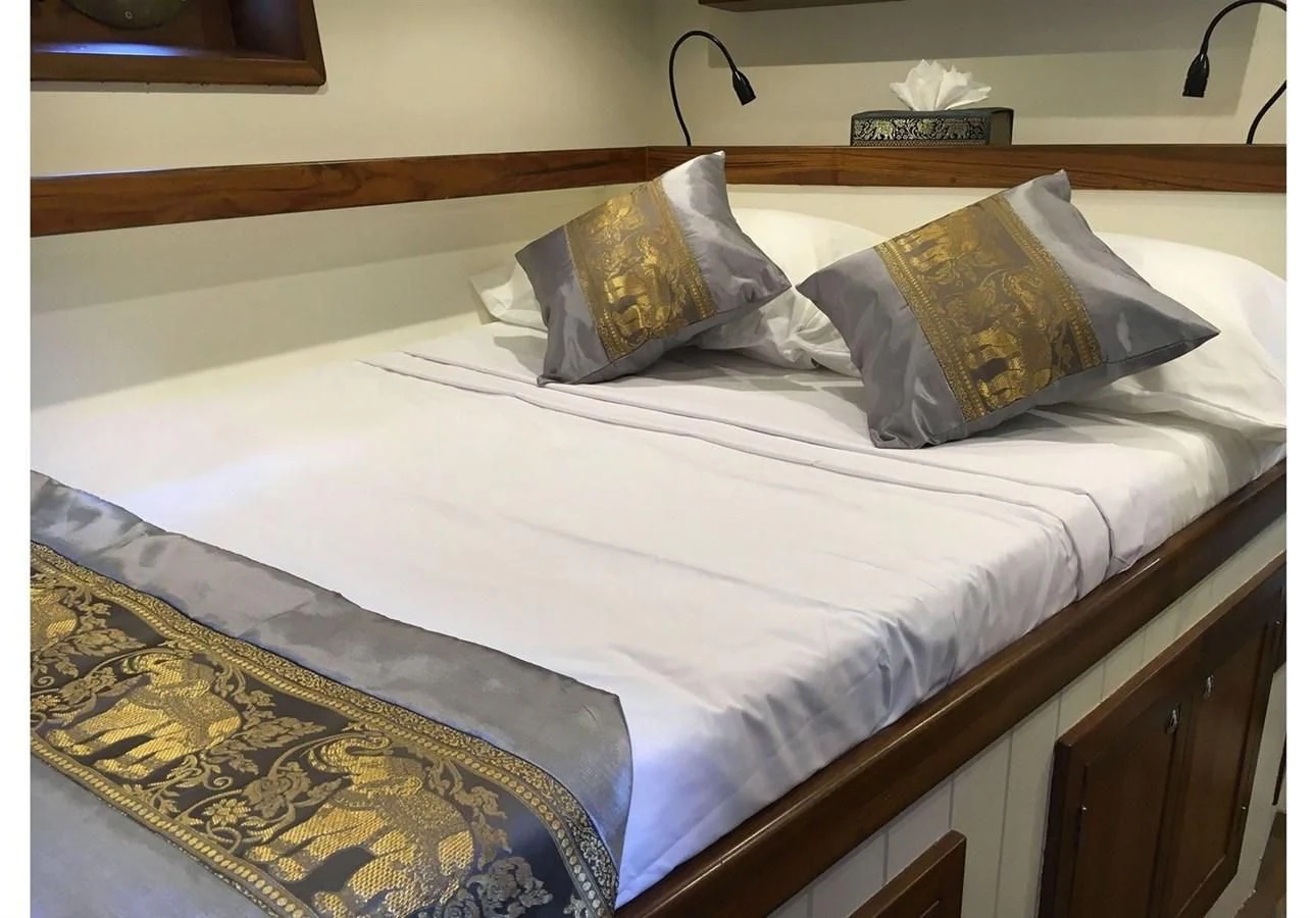 a bed with white sheets aboard DALLINGHOO Yacht for Sale