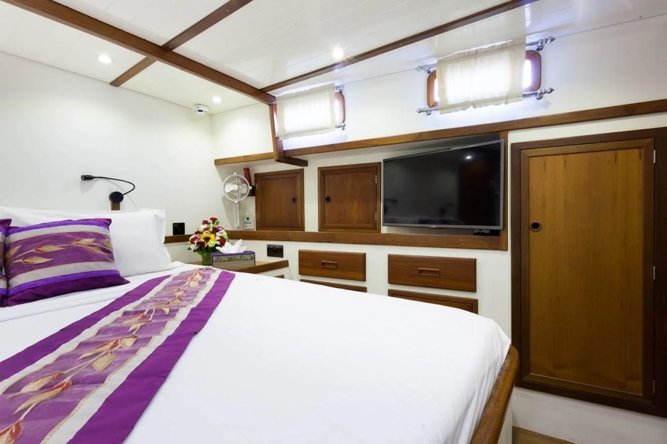 a bedroom with a bed and a television aboard DALLINGHOO Yacht for Sale
