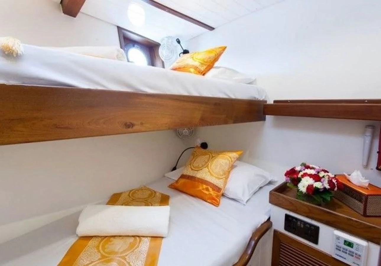 a bed with a flowered pillow aboard DALLINGHOO Yacht for Sale