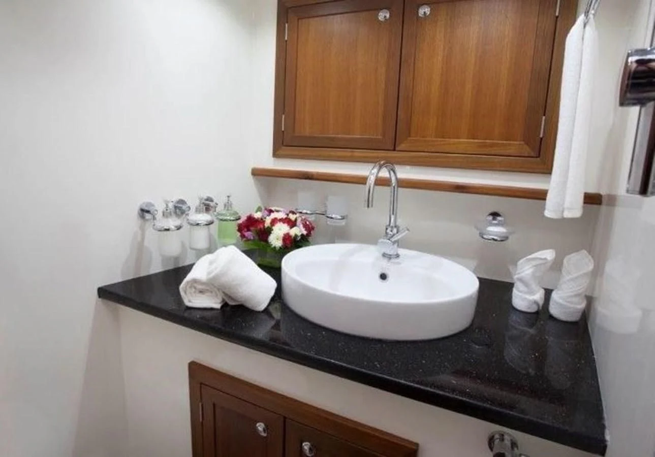 a bathroom sink with a black countertop aboard DALLINGHOO Yacht for Sale