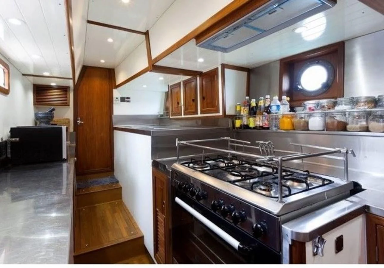 a kitchen with a stove and oven aboard DALLINGHOO Yacht for Sale