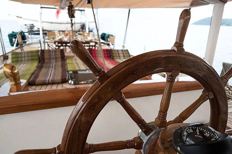 a wooden wheel with a wooden frame aboard DALLINGHOO Yacht for Sale