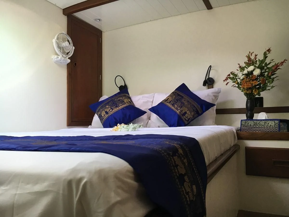 a bed with blue sheets aboard DALLINGHOO Yacht for Sale