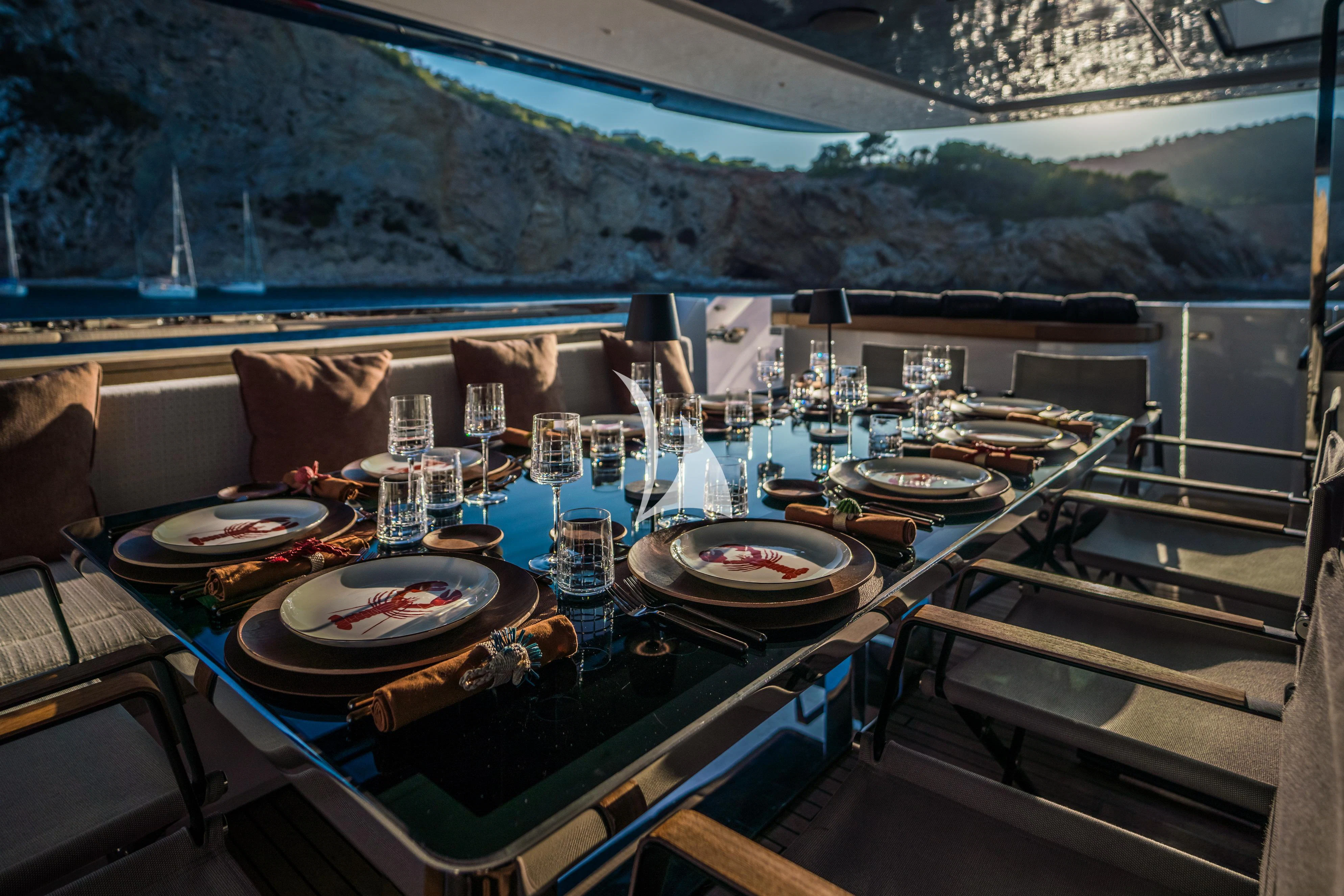 a table with plates and glasses on it aboard ALVIUM Yacht for Sale