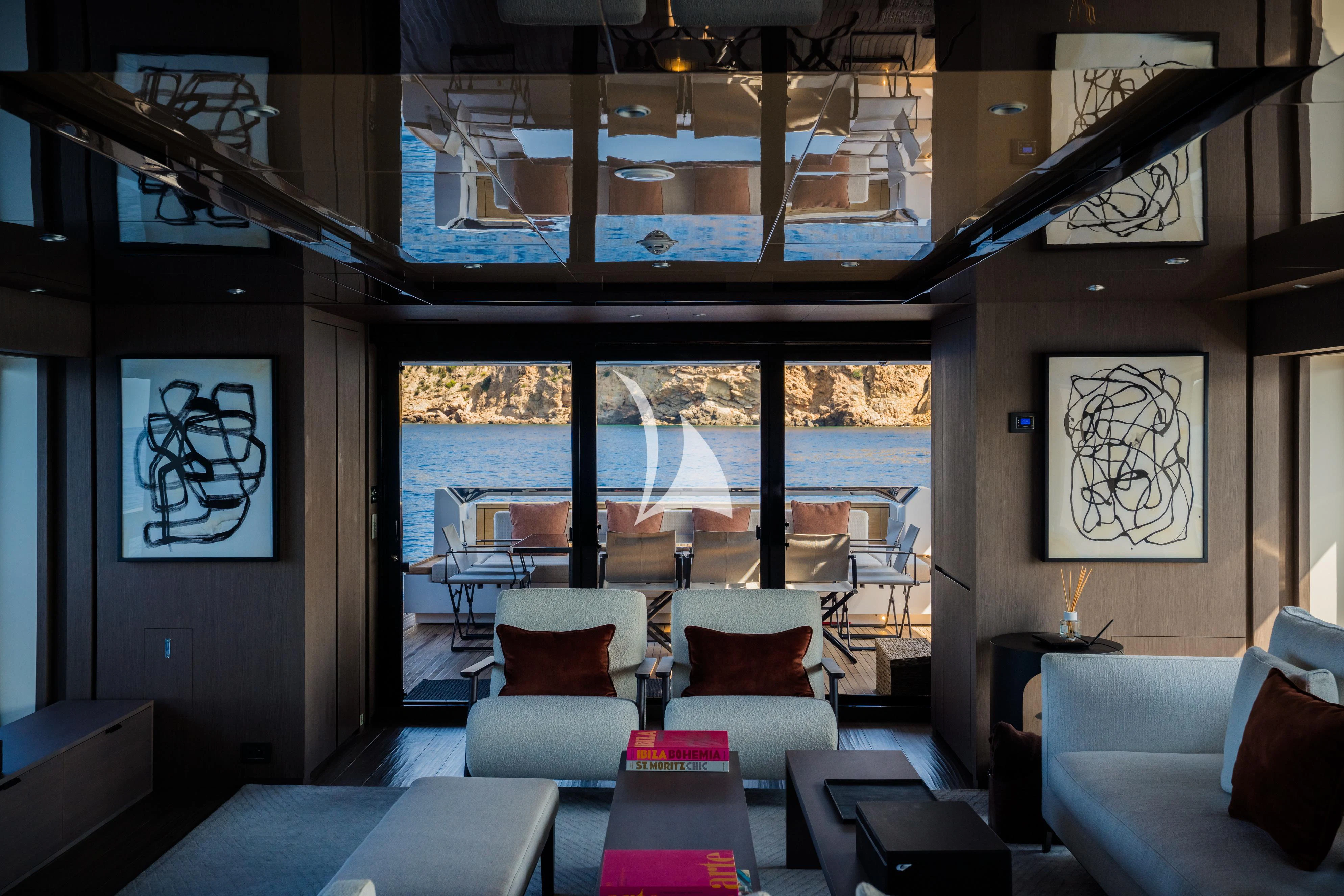 a room with a couch and a table and chairs aboard ALVIUM Yacht for Sale